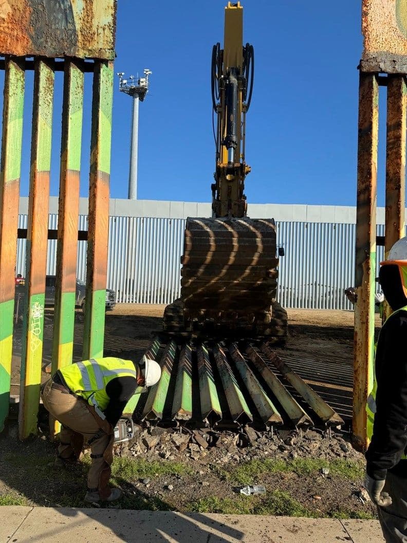 A photo of one of the sections of border wall from Friendship Park being removed by an excavator. Photo by Maria Teresa Fernandez